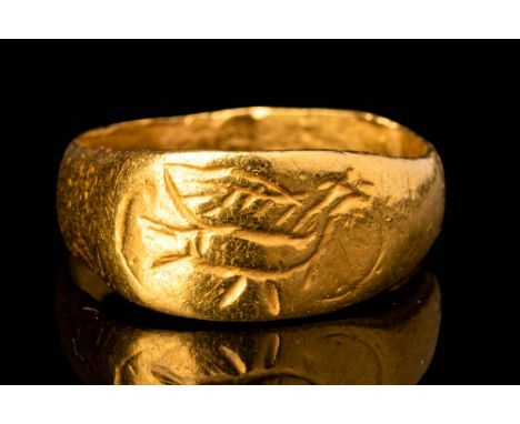 Ca. AD 600 - 900.A Byzantine 22 ct gold ring with a round, flat-sectioned hoop, and flat bezel depicting a stylised Dove. The