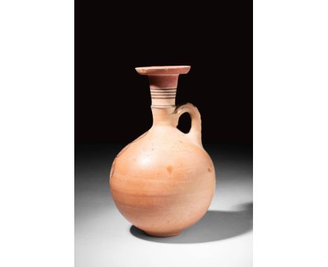 Ca. 900 - 600 BC.A Cypriot bichrome pottery jug decorated with black circles on the neck. The jug has a globular body and an 