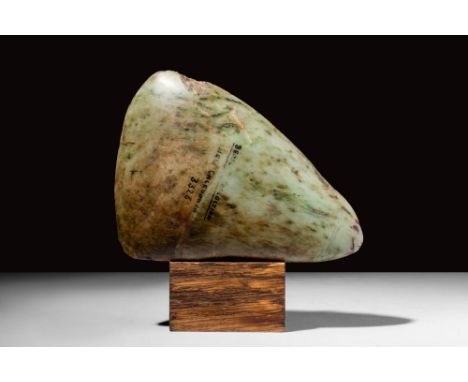Ca. 4500 - 4000 BC.A Neolithic jadeite head of a triangular shape, made to be attached to a wooden handle. This weapon would 