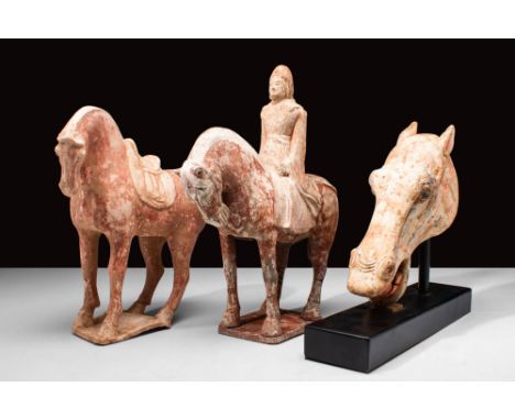 Tang Dynasty, Ca. AD 618 - 907.A group of three terracotta Tang dynasty statues. They consist of a horse, a rider on a horse 