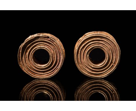 Ca. 1st Millenium BC.A pair of gold earring reel-shaped with a cylindrical body closed with two decorated disc and concentric