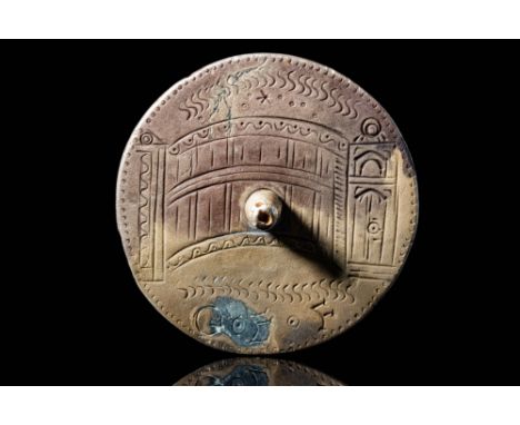 Ca. AD 100 - 300.A Roman silver weight decorated with an engraved scene of a bridge between two gates, stars in the sky and t