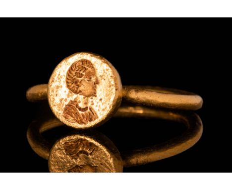 Ca. AD 500 - 700.A Byzantine 21 ct gold ring with a circular bezel depicting a bust of St. Helena facing right connected to a