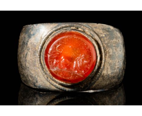 Ca. AD 100 - 200.A Roman silver intaglio ring engraved with profile of a lion facing right realised in naturalistic manner wi