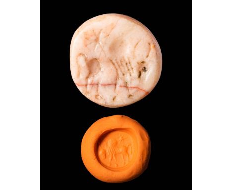 Ca. AD 200 - 400.A Sasanian pink hard stone stamp seal depicting a bull facing right and a star in the sky with highly stylis