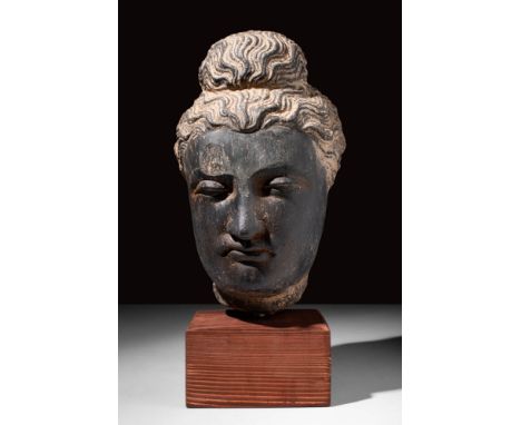 Ca. AD 100 - 300.A schist stone head of Buddha with naturalistic features of the head including deep-set almond-shaped half-c