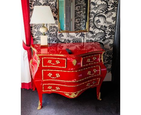 A red painted continental bombe commode, having brass fittings, containing two short over two long drawers122w x 86hx 60d cm