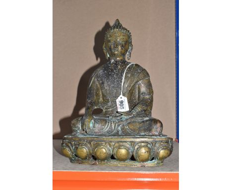 A COPPER-BRASS ALLOY STATUE OF A SEATED BUDDHA with etched patterns to the textiles, a hollow interior, height 39cm x width 2
