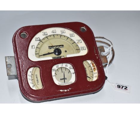 A LANCHESTER LD10 DIAL PANEL, dark red painted finish, with dials for speed, petrol, water and amps, width 17cm x height 15.5