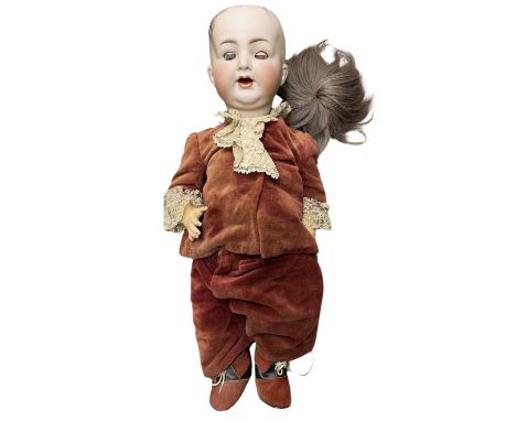 A large bisque head boy doll by Kammer and Reinhardt / Simon and Halbig.Marked to rear of head: K&amp;R -  Simon and Halbig -