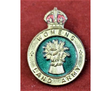 British WWII Women's Land Army badge worn on headwear or the uniform green jumper. Gilt and enamel with makers mark H.W.M. on
