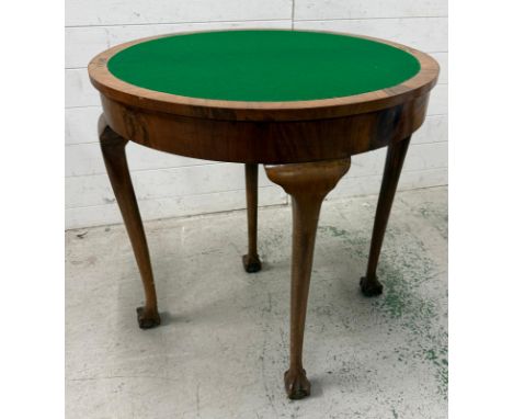 A burr walnut demi-lune card or games table on claw and ball feet, the top opening to a green baize playing surface (H76cm W7