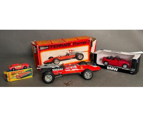 A Schuco Ferrari Formel 2 clockwork car boxed along with a Matchbox Lamborghini Marzal and a BMW Z4