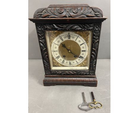 An oak carved bracket mantel clock
