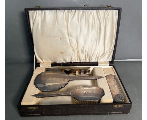 A silver backed vanity set, in original case to include two brushes, handheld mirror and comb. Hallmarked for Birmingham 1936