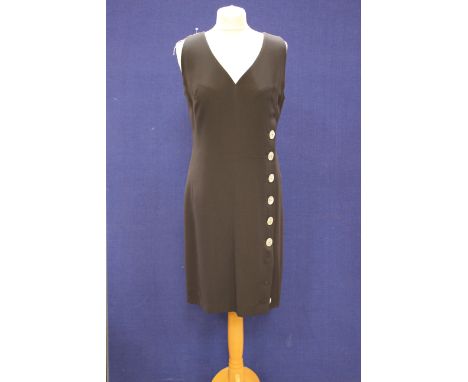 An iconic Caroline Charles black crepe sleeveless dress 1980s with button detail ring through dress 