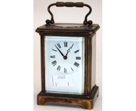 A brass carriage clock, enamelled face, Roman numerals, key 