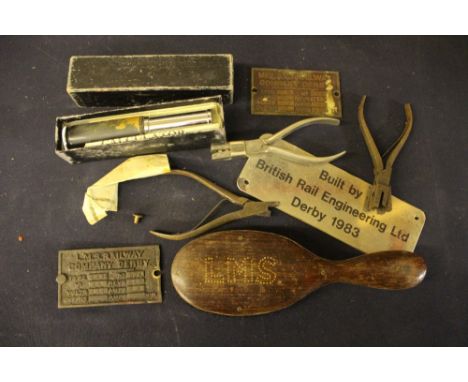 A collection of various railway related items to include Midland and LMS brass plaques, ticket punches, etc 
