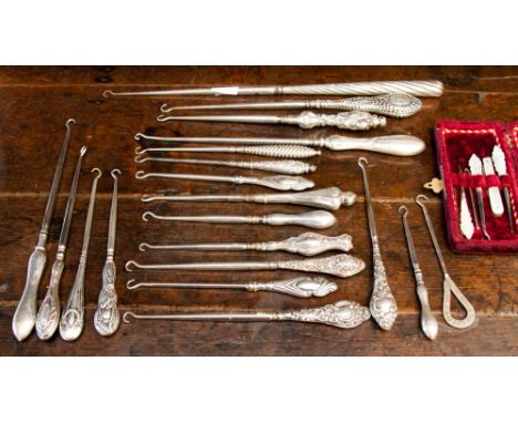 A good collection of nineteen silver handled button hooks and one other of varying sizes, with ornate decorative handles, mos