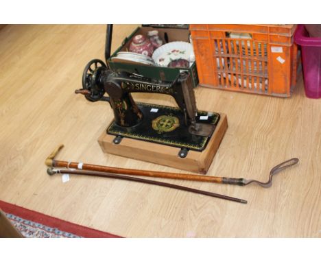 A riding crop and swagger stick, a Singer sewing machine (no cover and base replaced)

(3)