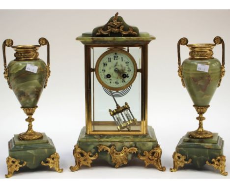 A green and glass bevelled mantel clock  French, circa 1900 with Arabic numerals, together with a pair of onyx and gilded met