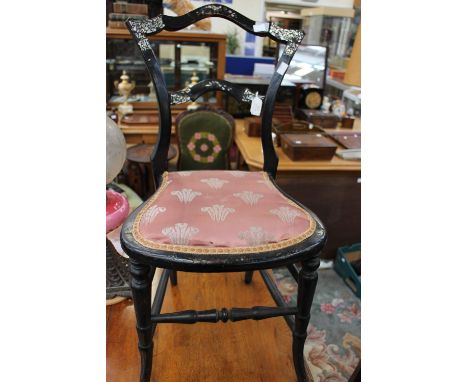 A Victorian Aesthetic black lacquered bedroom chair, inlaid with mother-of-pearl to crest rail, fitted with a padded seat, ra