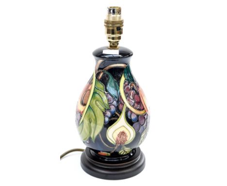 A Moorcroft contemporary lamp, of baluster form, with tube lined decoration on a deep blue ground, label to underside and rea