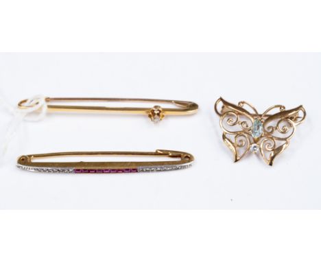 An 18ct ruby and diamond tie pin with calibre cut rubies together with a diamond set tie pin and a 9ct openwork butterfly bro
