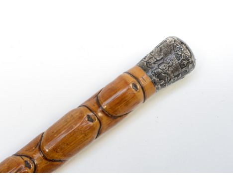 A bamboo walking stick, having a white metal embossed top, in Oriental pattern, dating from circa early 20th Century 