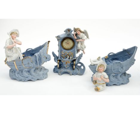 A German blue bisque figural clock garniture comprising mantle clock and two wishing wells, one af (3) 
