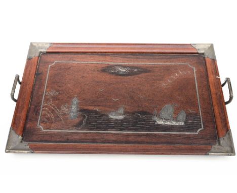 A Chinese hardwood serving tray, the centre with a white metal inlaid seascape depicting sailing ships and a pagoda, white me