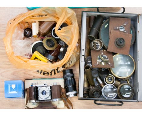 A box of vintage lenses, including two large magic lantern lenses and lenses by Taylor Hobson, Wrey London, Schneider, etc 