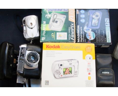A Maginon digital camera, Fuji Film digital camera A403 Kodak easyshare c300, Konica camera together with a vintage Halina Pa