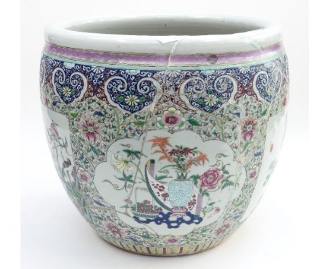 A Chinese famille rose fish bowl jardiniere, Qianlong style, 19th Century, with band of ruyi heads above panels of birds and 