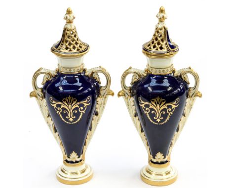 A pair of Coalport twin handled pot-pourri with reticulated covers (one finial re-glued) (2) 