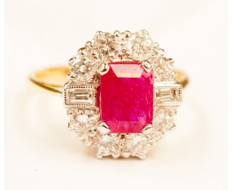 A ruby and diamond cluster yellow gold ring, the central octagonal step cut ruby weighing approx. 1.90 ct, the diamond surrou