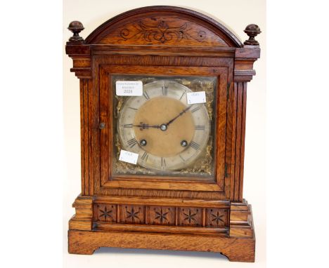 An oak mantle clock, Roman numerals, stamped N.B to workings, bevelled glass key and pendant 
