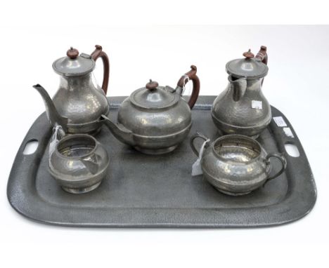 A hand hammered pewter five piece tea and coffee service and tray