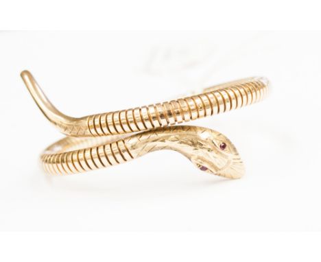 A 9ct gold snake bangle with small ruby eyes, weighing approx 248 grams approx 