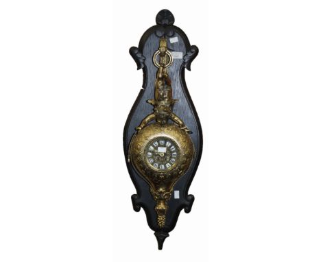 A gilt metal clock with putto mount on wooden bracket 