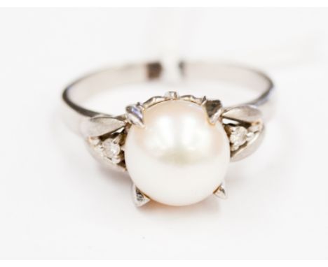 A pearl solitaire platinum ring, with diamond set shoulder 