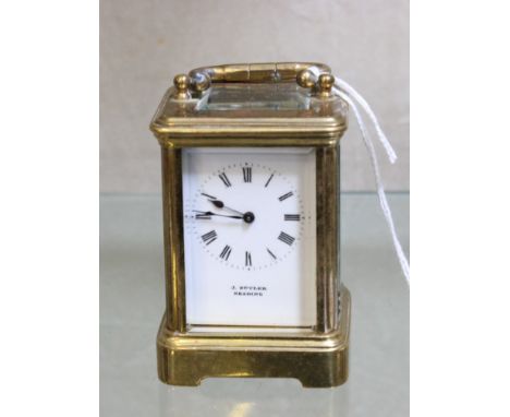 A French lacquered brass miniature carriage timepiece, Retailed by J. Butler, Reading, circa 1900, the eight-day single train