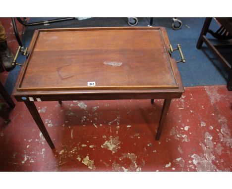 A mahogany brass bound butlers tray on stand on square section folding legs and an Edwardian oval coffee table and a George I