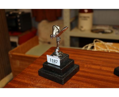 A Spirit of Ecstasy style car mascot raised on step base (12)