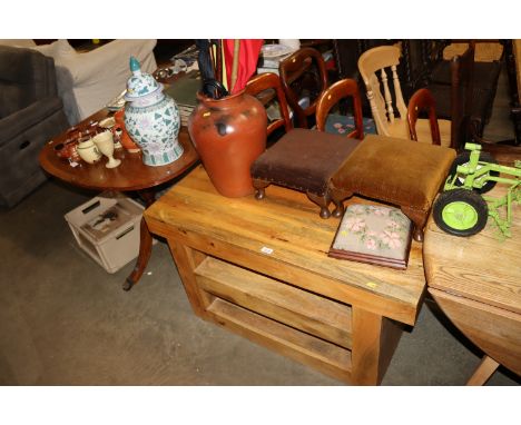 A modern hardwood shelf unit; three various footstools and a vase containing shooting stick, walking sticks and umbrellas 