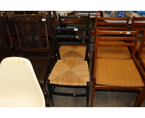 A pair of ebonised ladder back dining chairs with string seats 