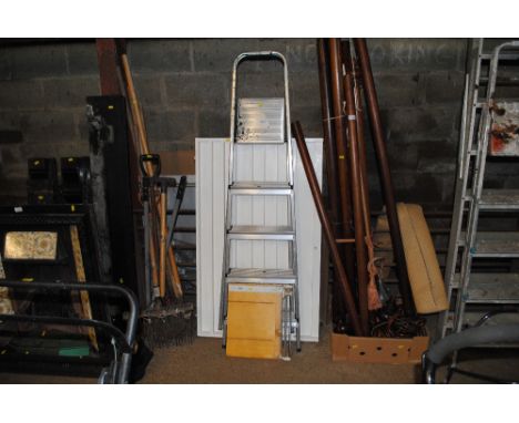 A white painted shelving unit, a guillotine and an aluminium step ladder