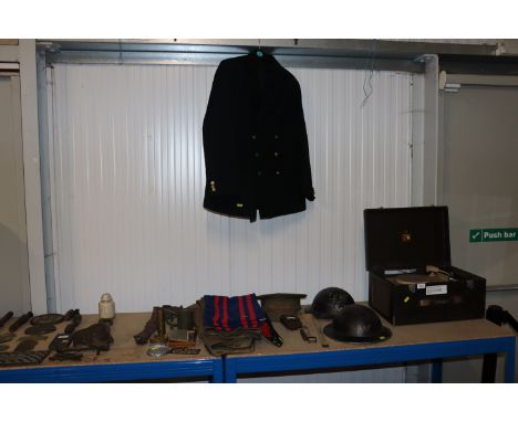 Two WWII period wardens helmets, an Army cap, a WWII period Royal Artillery cap, other items of uniform, spurs, belt, a Naval