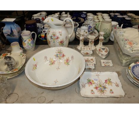 A floral decorated toilet jug and basin, a matching dressing table set etc.