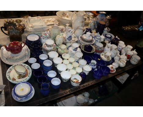 A large collection of various patterned tea and dinner ware to include Foley China, Staffordshire, Queens 'Blue Iris' pattern